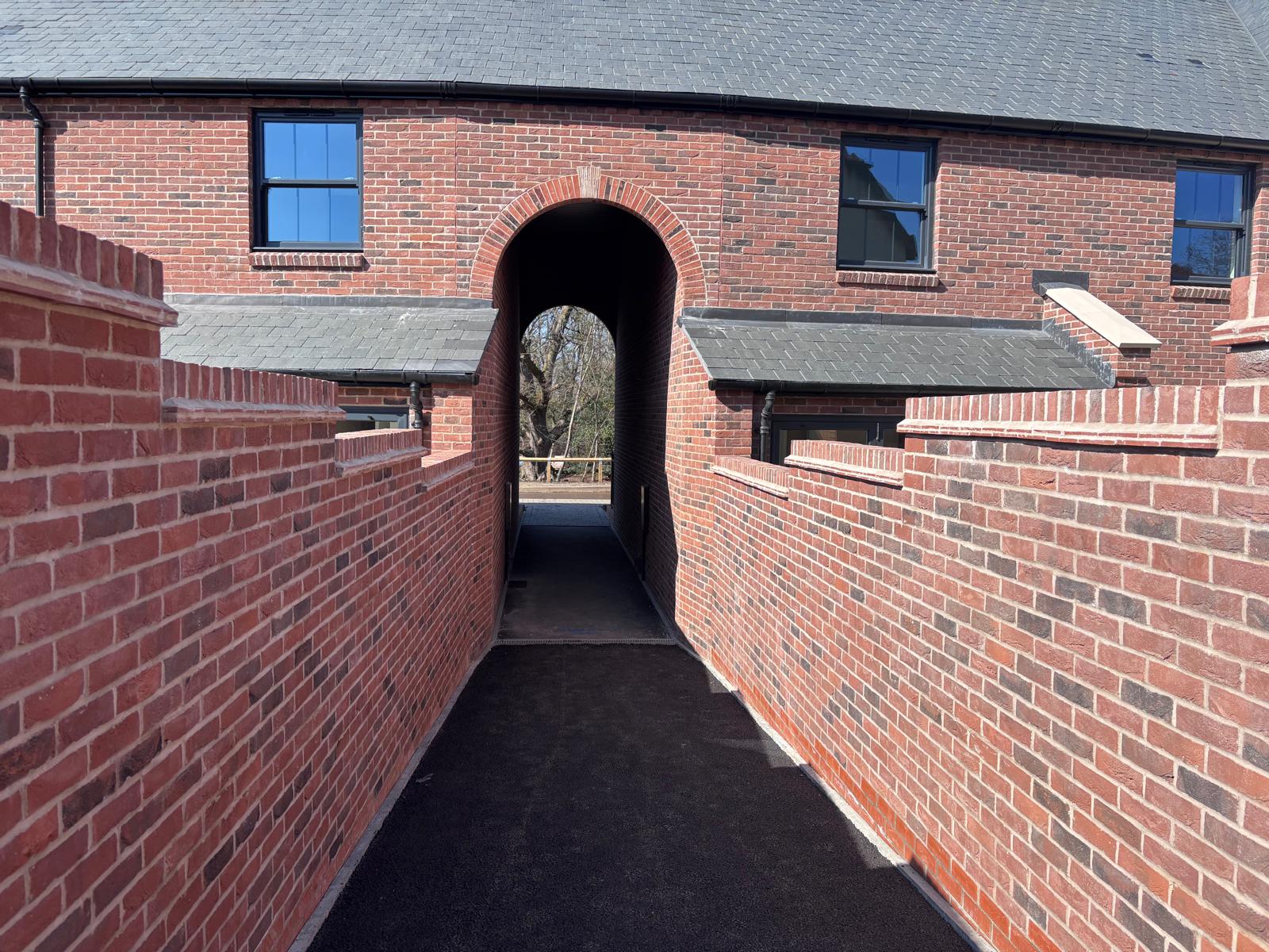 BOSC brick archway opening onto a private courtyard