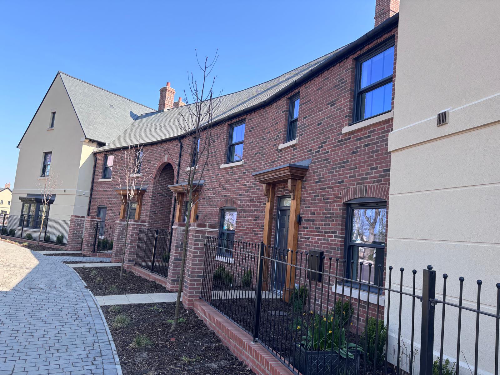 BOSC streetscape — terraces with iron railings and stone wall