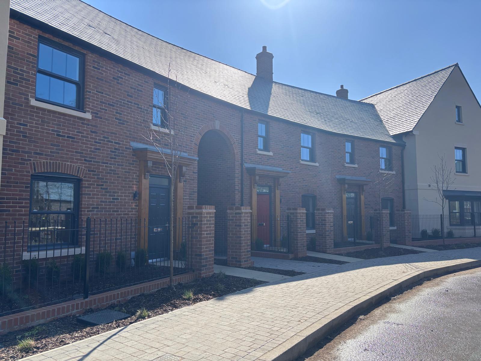 BOSC paved courtyard between brick and render terraces