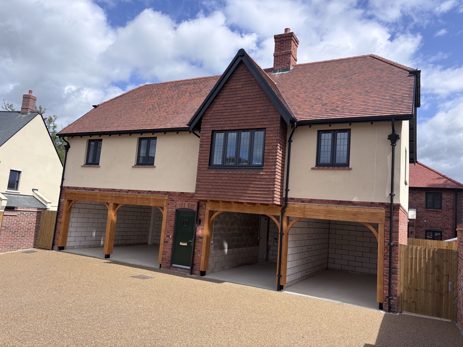 Brick and render coach house with garages at the BOSC development
