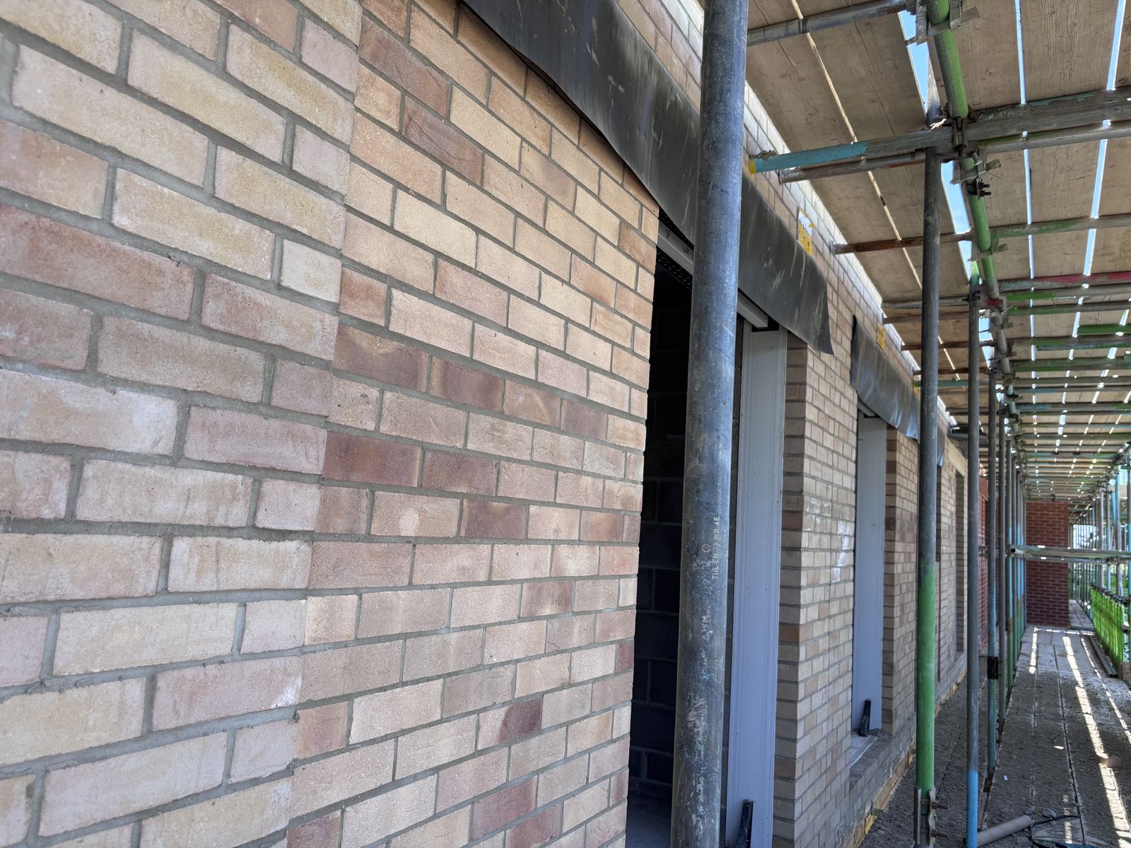 Brick elevation under scaffolding at the Chichester development