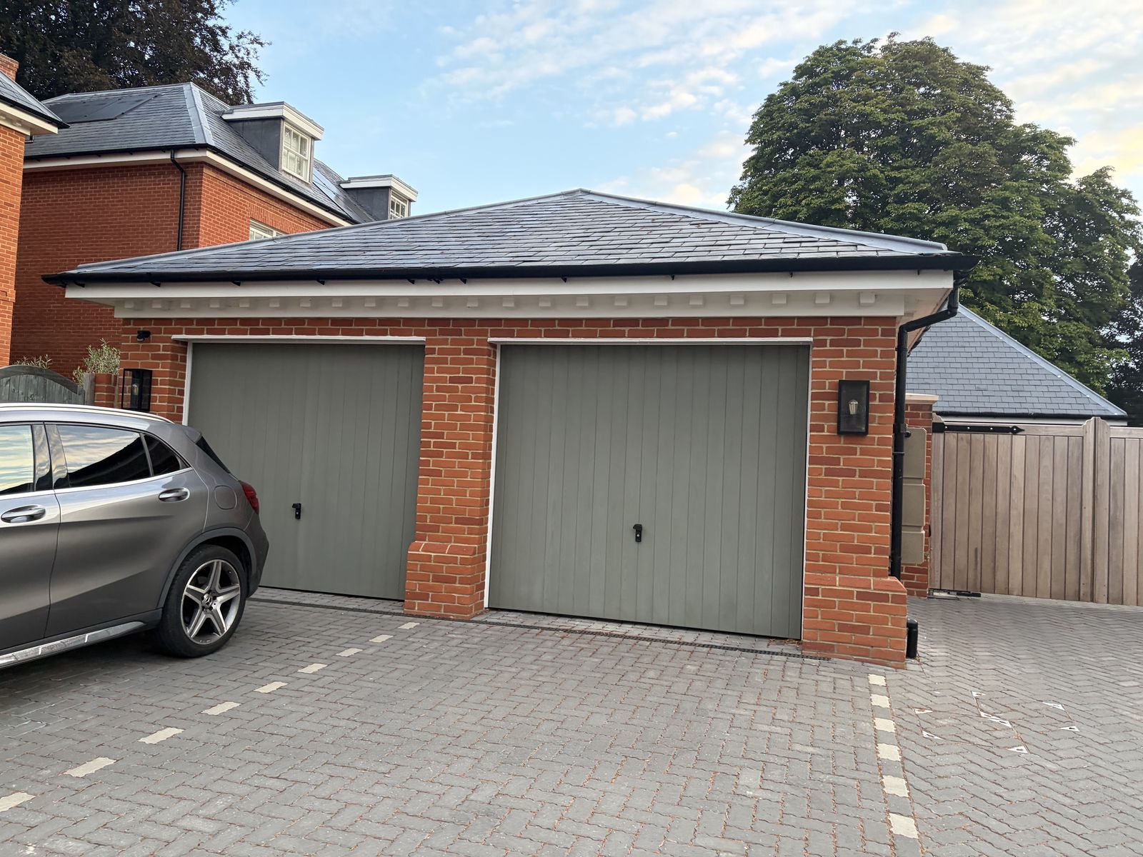 Red-brick double garage at the St Cross Road development