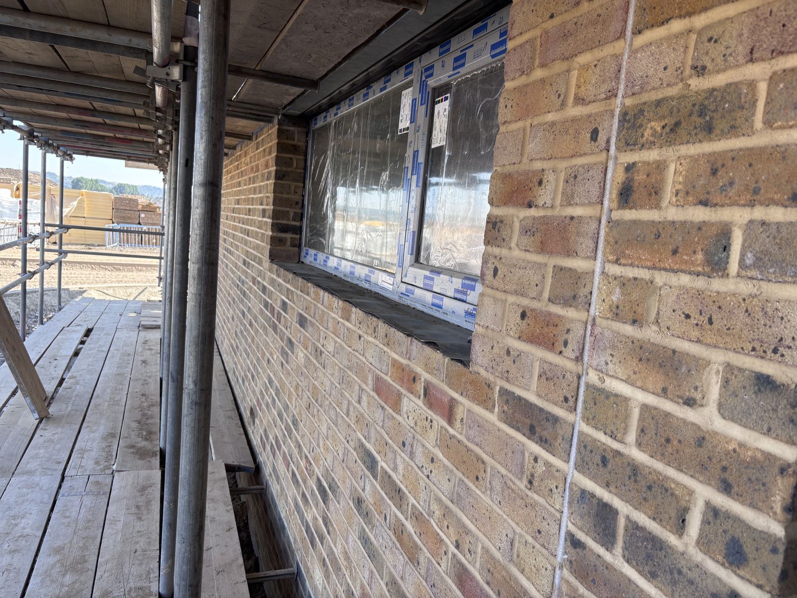 Brickwork and windows under scaffolding at Tipner East