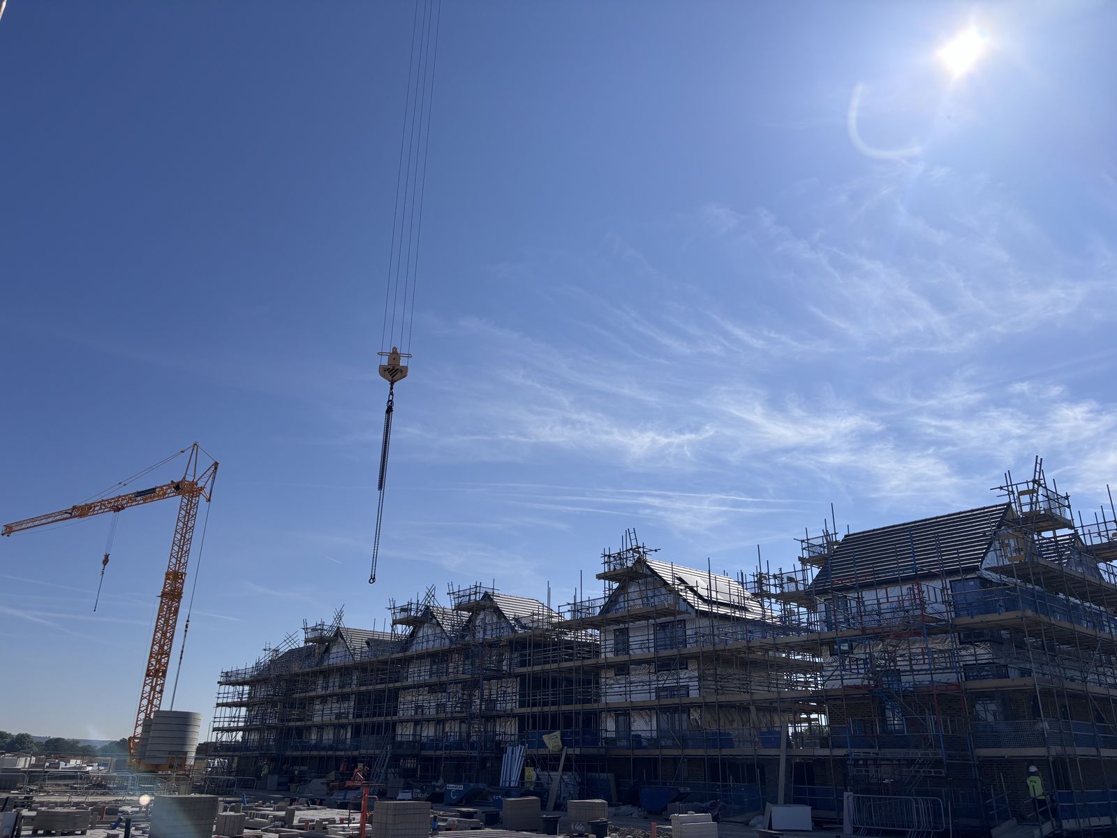 Scaffolded buildings and tower cranes at Tipner East